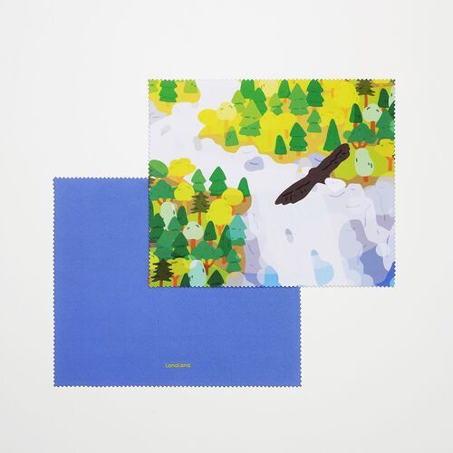 A colorful evergreen forest scene with a small bird rests over a solid blue reverse in this detailed product view.