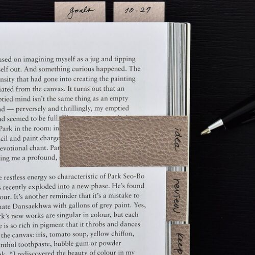 Saddle Leather Bar notes mark several pages in a book, with handwritten labels visible along the outer edge.