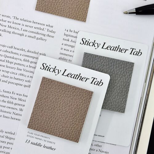 Saddle Leather and Pebble Gray Square notes sit over an open book, adding visible page markers and memo space.