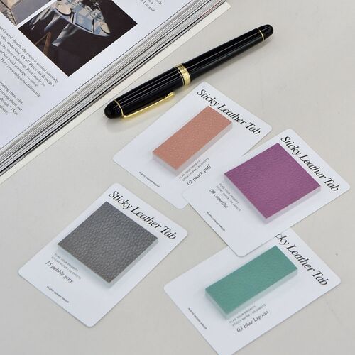 Peach Puff Square notes are used on an open book beside a fountain pen, showing a clean setup for reading notes.
