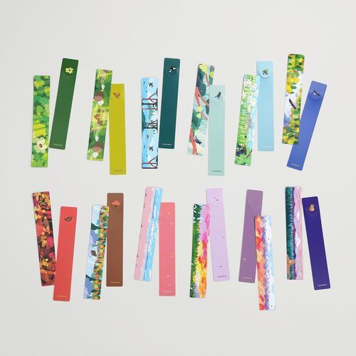 Several bookmark designs are paired with books and Seattle-themed stationery, highlighting their slim format for everyday reading.