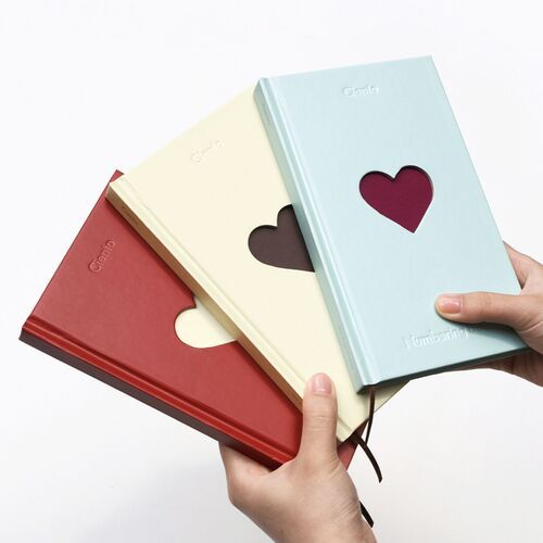 The three color options are held side by side, highlighting the slim hardcover format and contrasting heart windows.