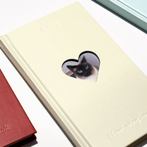 The page edges and ribbon bookmarks are visible across stacked journals, showing the sturdy bound construction.