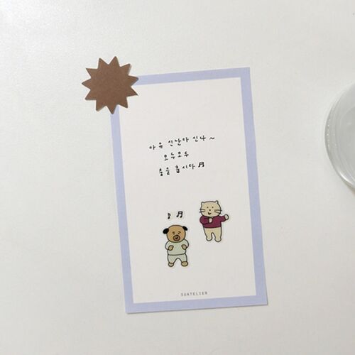 Two small stickers decorate a bordered note card, showing how the dancing characters add a quick personal touch.