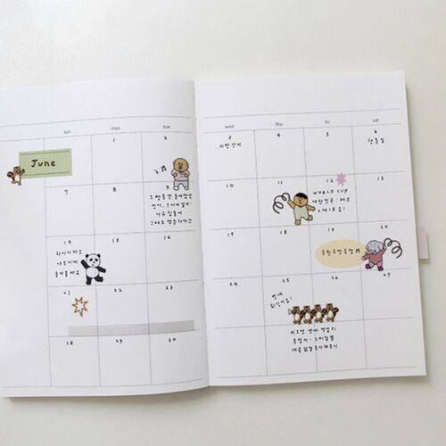 The open monthly spread uses several stickers across calendar boxes to mark dates and create a lively layout.