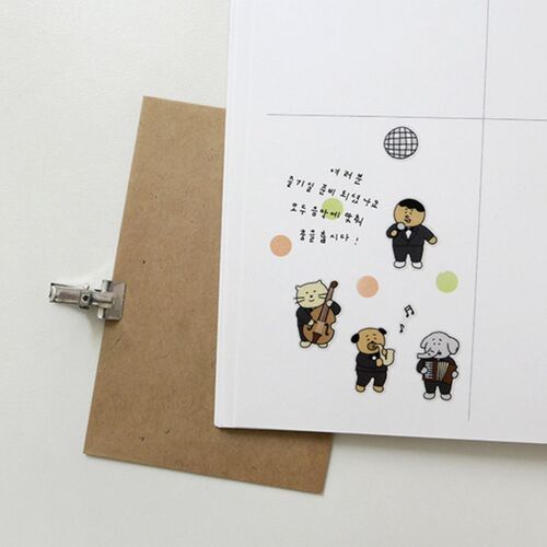The sticker sheet rests over a kraft clipboard, giving a clear look at its slim paper format and white sticker edges.