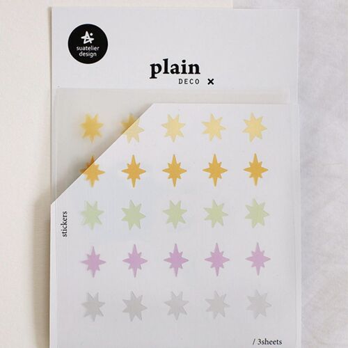 A closer view shows the Plain Deco packaging and the evenly spaced starburst stickers across the white sheet.
