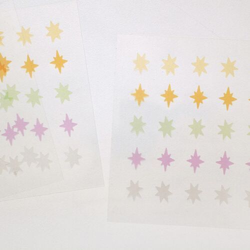 Two sheets are shown together, revealing the soft color palette and repeating starburst layout from different angles.