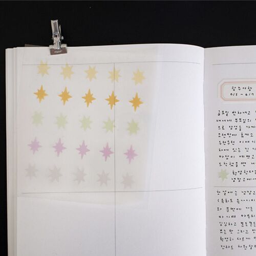 Small green and golden yellow starbursts accent handwritten notes and create a simple decorative border on the page.