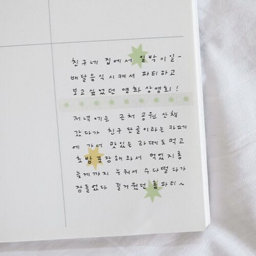 The open monthly spread shows the stickers used with labels, illustrations, and handwritten entries across several calendar squares.