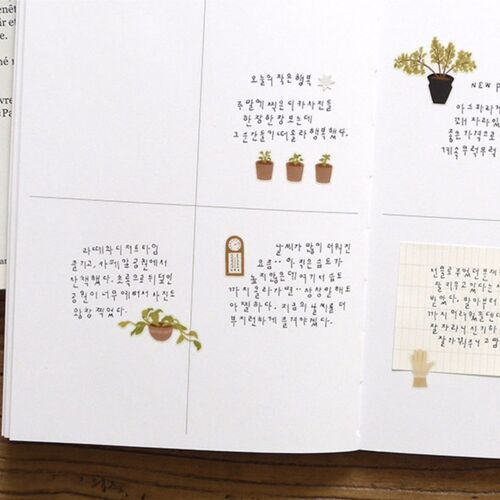 The open notebook spread shows how the botanical stickers can be mixed with handwritten reflections and larger page sections.