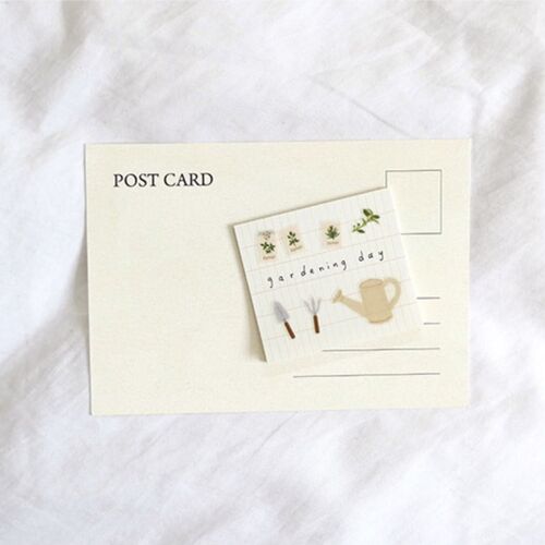 Plant stickers add gentle color to a monthly calendar, with a potted plant and leafy accents placed among the date boxes.