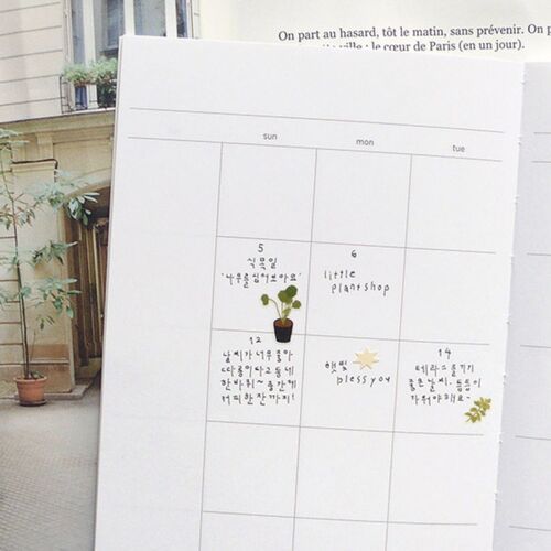 The packaged sheet is displayed vertically on a white fabric background, making the full range of plant and gardening illustrations easy to see.