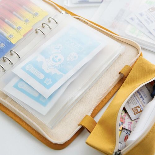 Inside the binder, a transparent Whole pocket protects colorful flat paper items while keeping their designs easy to see.