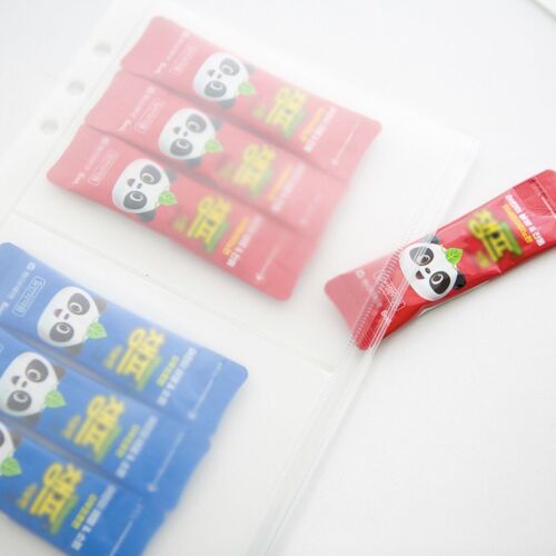 A binder pocket stores red and blue packaged items, demonstrating how the clear sleeve keeps contents grouped and visible.