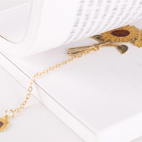Gold-tone chains connect each decorative bookmark to a smaller matching charm for a finished look.