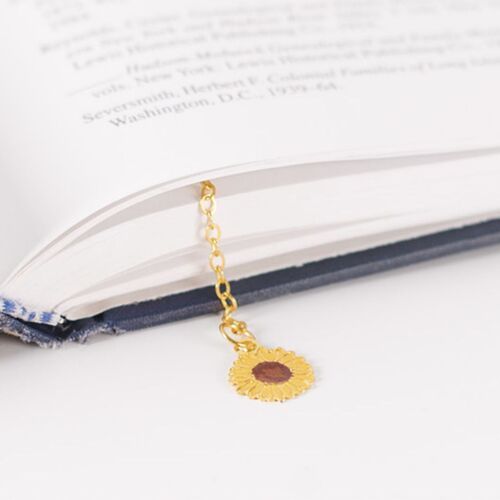 The slim metal pieces sit neatly against book pages without the bulk of a thick page marker.