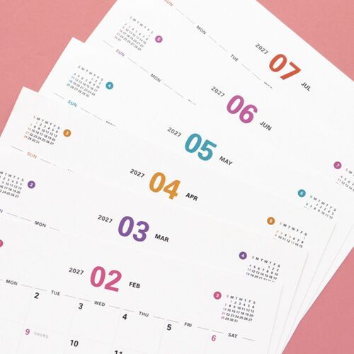 Several calendar pages are spread out to show the clean monthly format and varied page layouts.