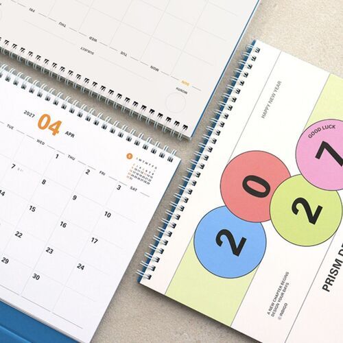 Multiple calendar sheets show large month numbers and small reference calendars for quick date checking.