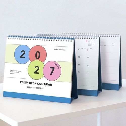The calendar stands near a laptop and stationery, ready for work planning and daily scheduling.