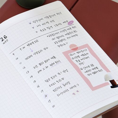 An open grid spread includes time-based notes and a side panel, supporting detailed daily organization.