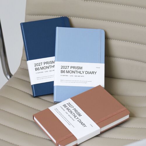 Two Milky Blue planners stand together, showing the cover texture, rounded corners, and matching bands.