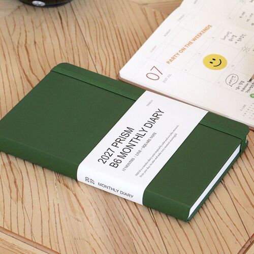 Classic Blue and Mocha Mousse planners overlap on a clean desk, showing their contrasting textured covers.