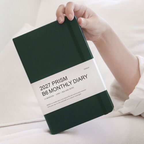 Butter Yellow is shown from the back with its matching elastic band and subtly textured hardcover surface.
