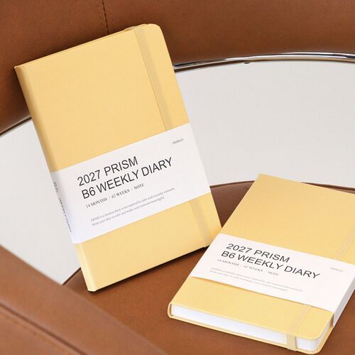 The Mocha Mousse cover is styled with a pencil and fabric, highlighting its warm color and elastic band.