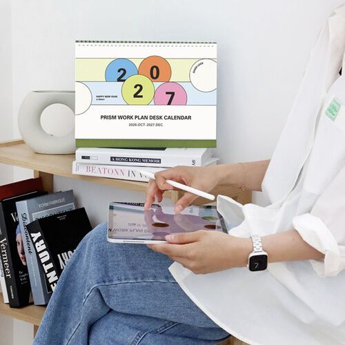 Placed beside a bright workspace, the calendar’s upright format keeps the 2027 schedule easy to see during the day.