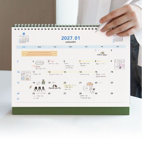 A close view shows a dated monthly page with weekday columns, writing space, and small reference calendars.