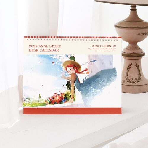 A front-facing display highlights the large calendar format, red standing base, and watercolor scene across the cover.