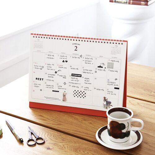 A monthly page displays a spacious Sunday-to-Saturday grid with small neighboring-month references and delicate illustrations.