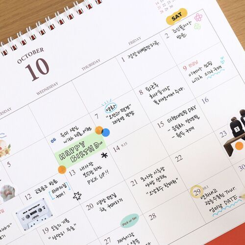 The dated May page features a large month number, spacious boxes, and a small illustrated figure among the calendar dates.