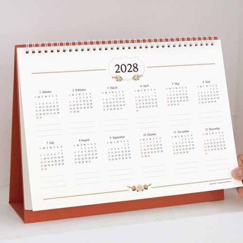 A close view of the February calendar shows abundant writing space alongside small black-and-white decorative motifs.