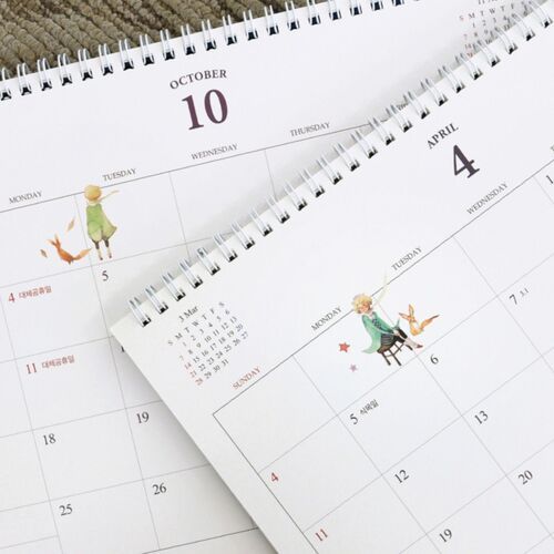 Close-up pages feature October and April layouts with small Prince Story artwork and ample blank space for notes.