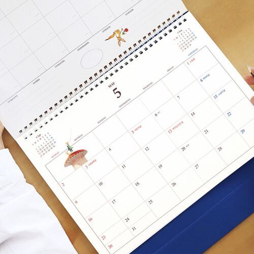 Another filled monthly view shows stickers, highlighted tasks, and handwritten entries arranged across the roomy calendar grid.