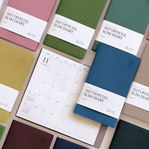 A Red Bean scheduler is shown in hand beside stacked color options, highlighting its slim profile and flexible everyday format.