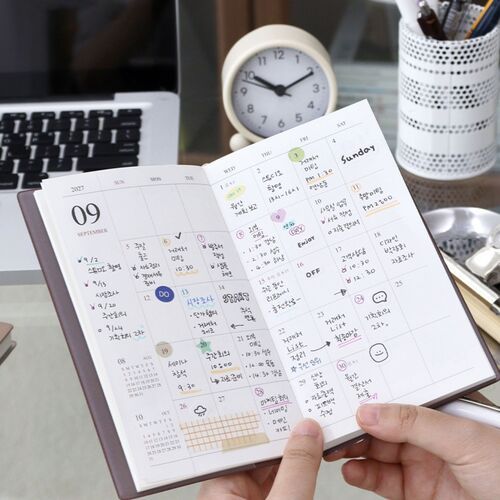Lined pages are filled with handwritten reflections and small photographs, creating a personal journal-style record.