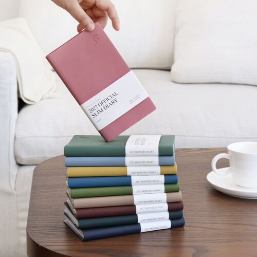 A Teal Blue scheduler stands in front of a coordinated stack, with the white product band around its center.