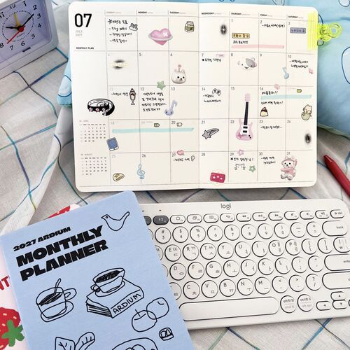 A Coffee Day cover sits beside a keyboard, highlighting the planner’s practical fit for desk work and scheduling.