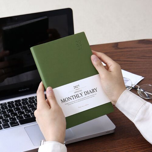 A Red Bean scheduler is shown at an angle with its white cover band and clean page edges.