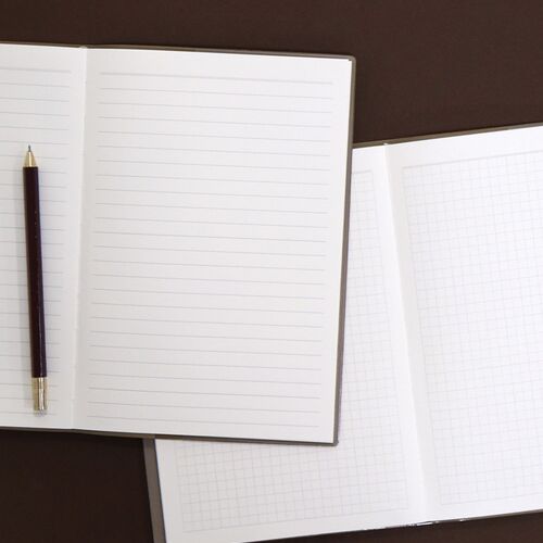 Lined and grid pages sit open side by side, offering two flexible formats for notes and planning.