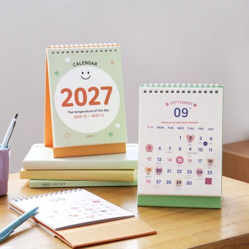 Photo 6: A close view shows an open monthly grid with generous date boxes and the orange standing base beneath it.