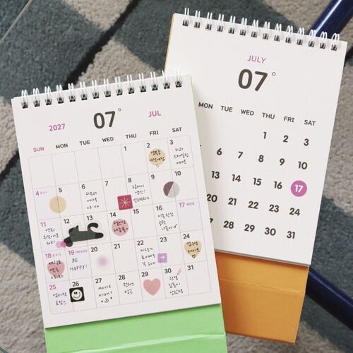 Photo 12: Close-up calendar pages show large month numbers from August through December in varied colors across a clean layout.