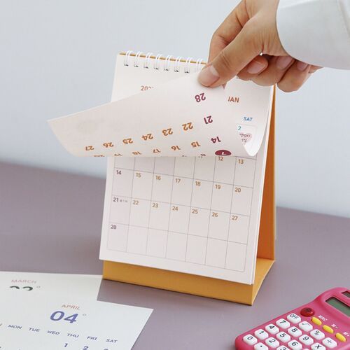 Photo 8: A June calendar page is shown beside a pale yellow pen, with colorful dates and small decorative illustrations throughout the grid.