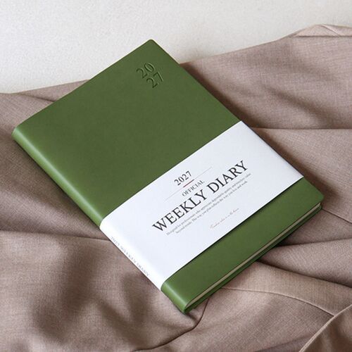 The Red Bean cover is held over a laptop, highlighting the compact book format and clean embossed year mark.