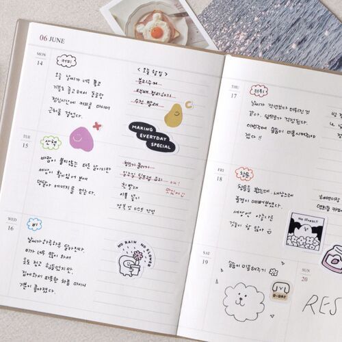 A close view shows decorative stickers and handwritten notes arranged within the dated weekly boxes.
