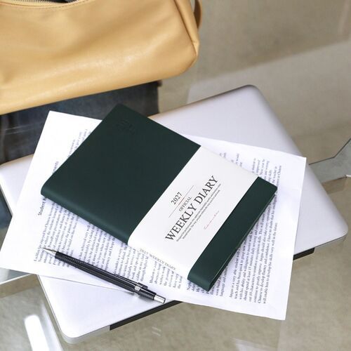 Mustard and Green Mousse schedulers are stacked with additional colors, creating a coordinated desk display.