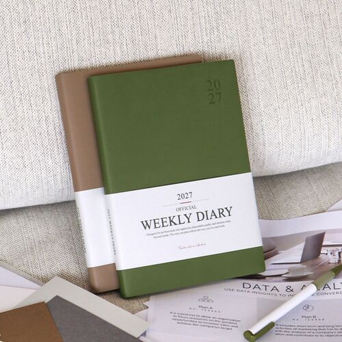 The Mustard cover stands against a wooden chair while another Green Mousse scheduler leans nearby.